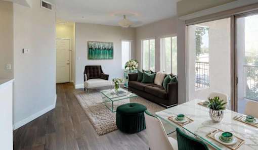 a living room and dining room with a table and chairs