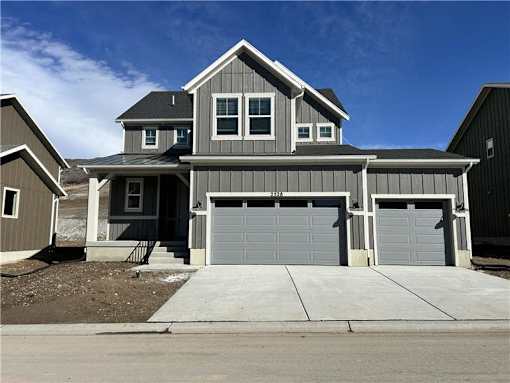 A two-story house with a garage is shown.