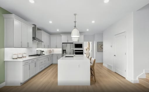 A modern kitchen with white cabinets and a large island.