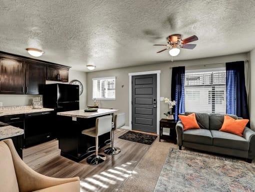 a living room with a couch and a kitchen