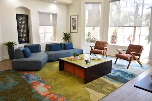 A living room with a blue couch and a coffee table.