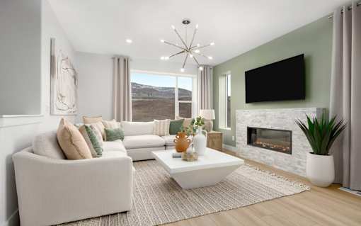 A modern living room with a fireplace and a flat screen TV mounted above it.