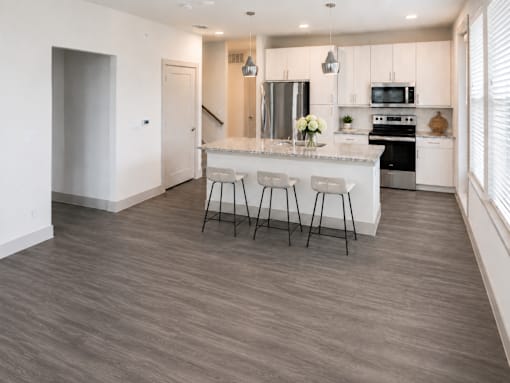 Modern kitchen island with bar seating at Avion at West Lemmon Apartments, Dallas, 75235