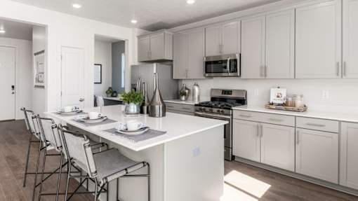 A modern kitchen with white cabinets and a central island.