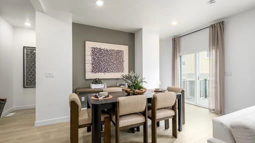 A dining room with a table set for four.