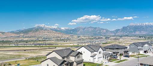A mountain range is in the background of a residential neighborhood.