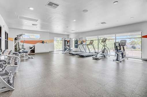 A spacious gym with a variety of exercise equipment.