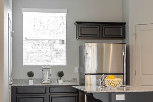 Kitchen with stainless steel refrigerator at The Village at Church & Main, Layton, 84041