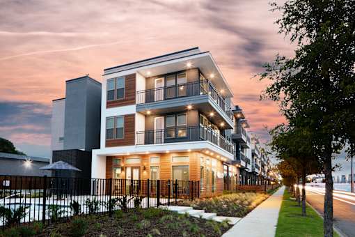 Modern apartment building exterior at dusk at Avion at West Lemmon Apartments, Dallas