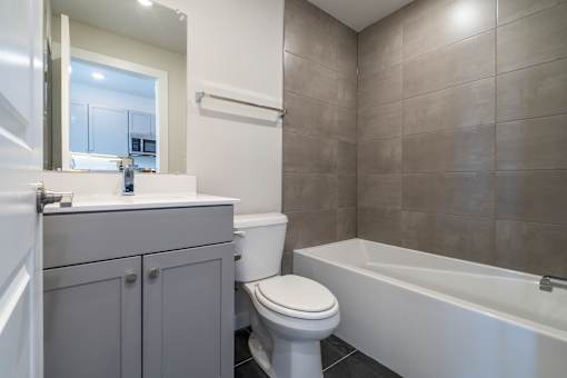 A bathroom with a toilet, sink, and bathtub.