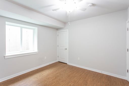A room with a window and a door.