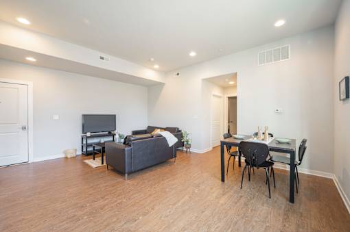 A living room with a grey couch and a television.