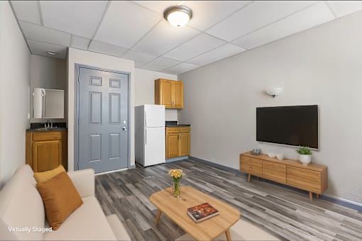 A living room with a blue door and a television.