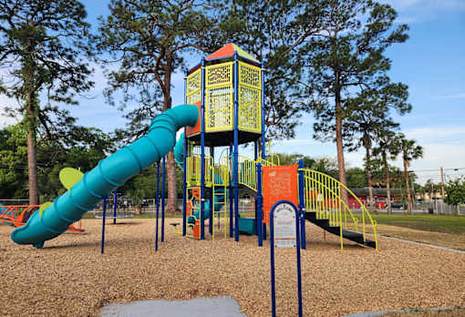 A playground with a blue and yellow slide.