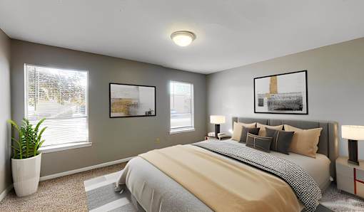 A bedroom with a large bed and two framed pictures on the wall.
