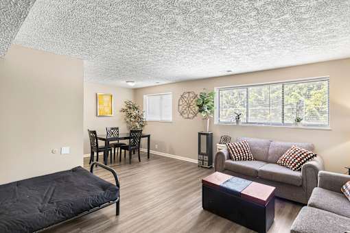 a living room with a couch and a table and a window