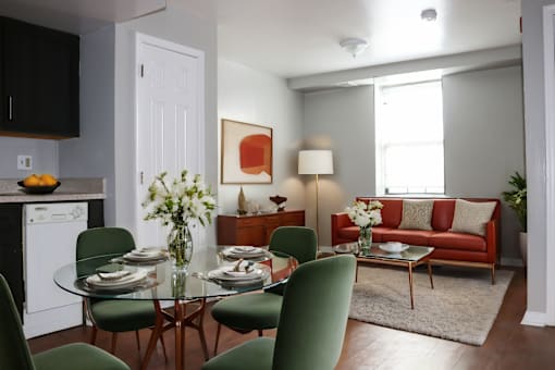 a living room and dining room with a table and chairs