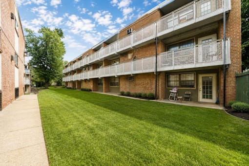Apartment building with green lawn in front.