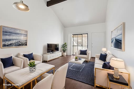A living room with a white couch and a coffee table.
