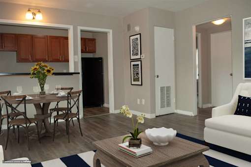 A modern kitchen with a dining table set for two.