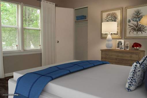 A bed with a blue blanket is in the foreground of a room with a window and a dresser.