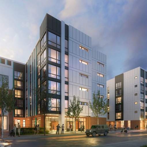 A modern multi-story building with people walking in front.
