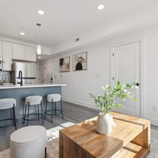 A kitchen with a bar area and a wooden coffee table.