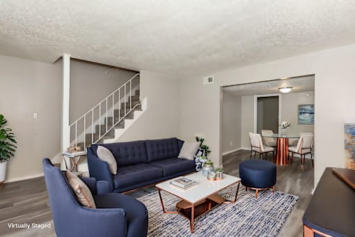 A living room with a blue couch and a coffee table.