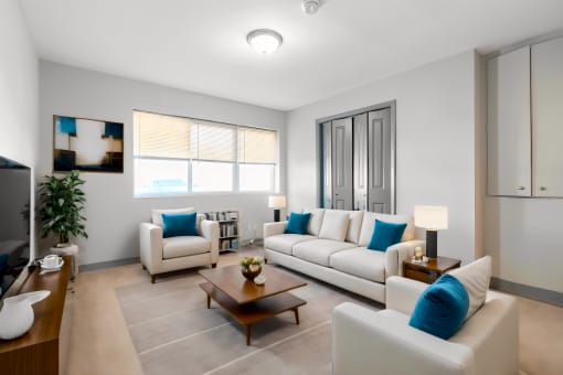 a living room with couches and chairs and a table