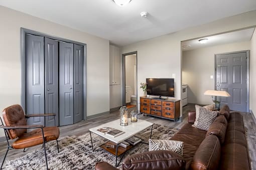 A living room with a brown leather couch, a coffee table, and a chair.