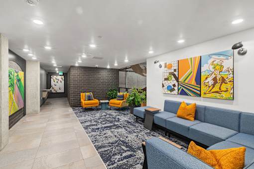 A brightly colored artwork hangs on the wall in a modern living room.