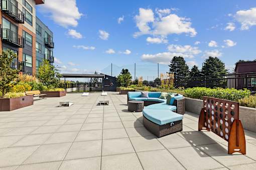 A sunny day at the outdoor seating area of a modern building.