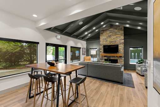 A modern dining room with a wooden table and chairs.