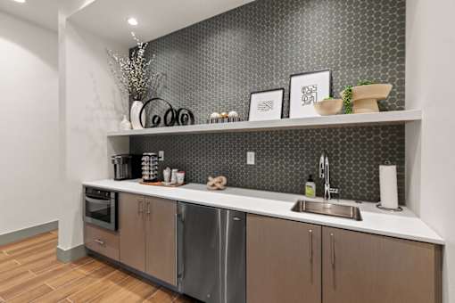 A modern kitchen with a stainless steel dishwasher and wooden cabinets.