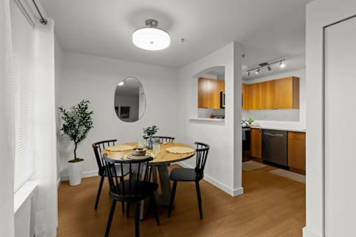 A dining room with a round table and chairs.