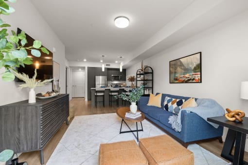 a living room with a blue couch and a table