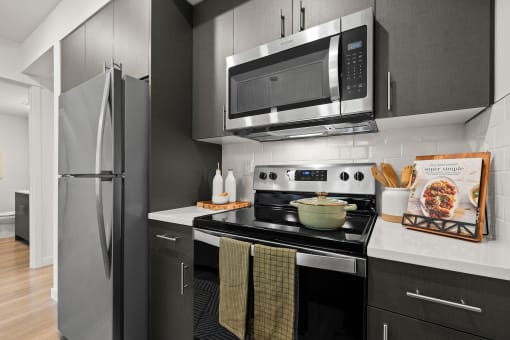 a kitchen with stainless steel appliances and a microwave