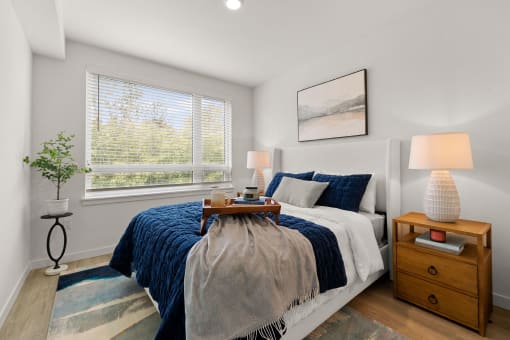 a bedroom with a bed and two windows
