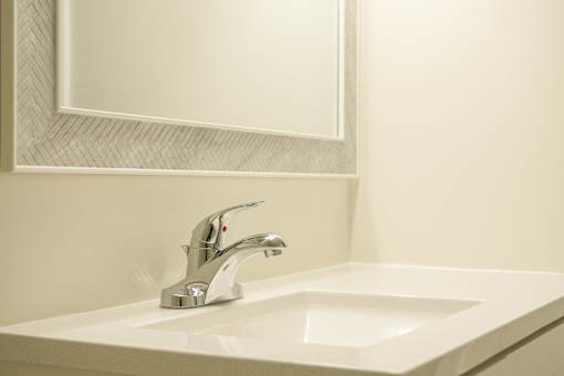 A white sink with a silver faucet in a bathroom.