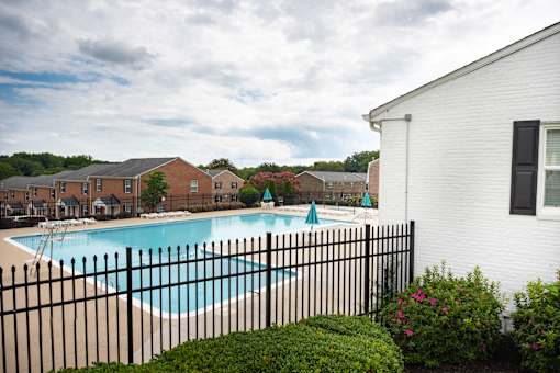 A black fence surrounds a small pool.