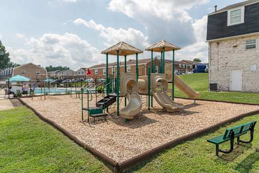 A playground with a slide, swings, and a climbing frame.