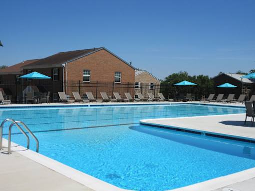 A large swimming pool with a metal fence around it.