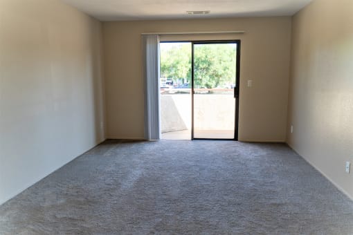 an empty living room with a door to a patio at Cowell Terrace Apartments, Concord, CA 94518