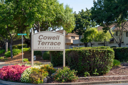 a sign for covenant terrace apartments in front of plants and trees at Cowell Terrace Apartments, Concord, 94518