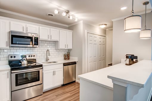 White cabinets and stainless steel appliances in select units at Triangle Park Apartments, North Carolina