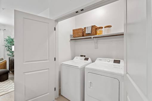 A white laundry room with a washer and dryer.