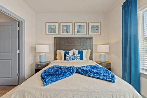 A bedroom with a large bed and a blue blanket.