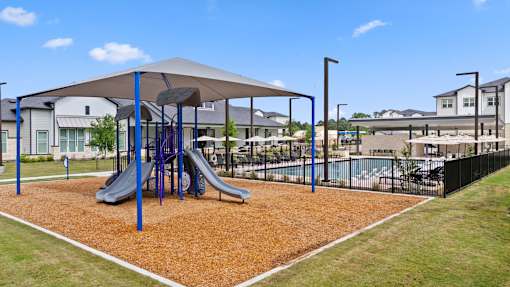 A playground with a slide and a swing set.