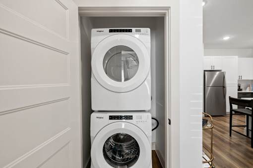 A white washing machine and dryer in a small laundry room.