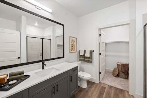 A bathroom with a white sink and a toilet.